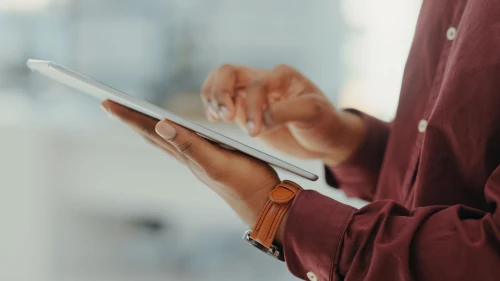 Closeup of man, tablet and hands in office for productivity, website planning and internet research. Male worker, digital technology and scroll app for online information, business data and analytics