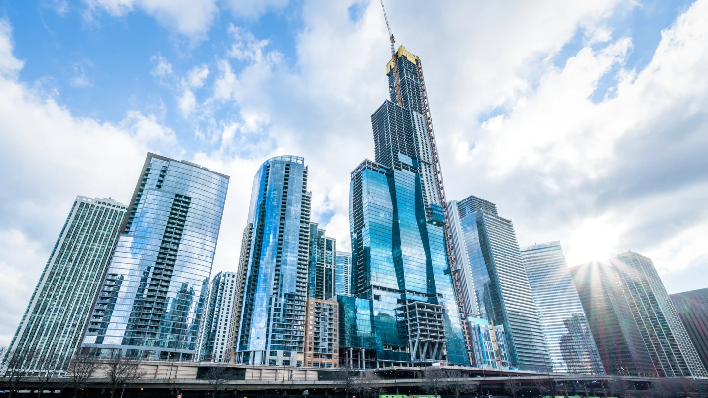 Modern tower buildings or skyscrapers in business district, reflection of cloud on sunny day in Chicago, USA. Advanced construction industry, modern company, or real estate project development concept