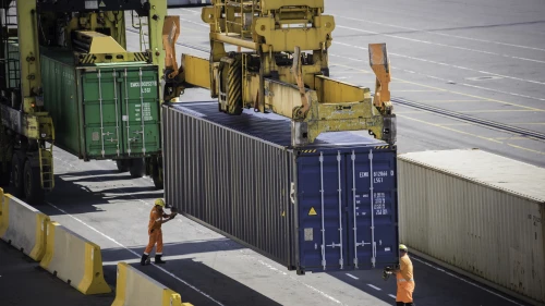 Dockers locked a container elevated on container ship