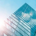 Architecture of modern skyscraper in business district with sun light. Smart city business background concept or use for website background.