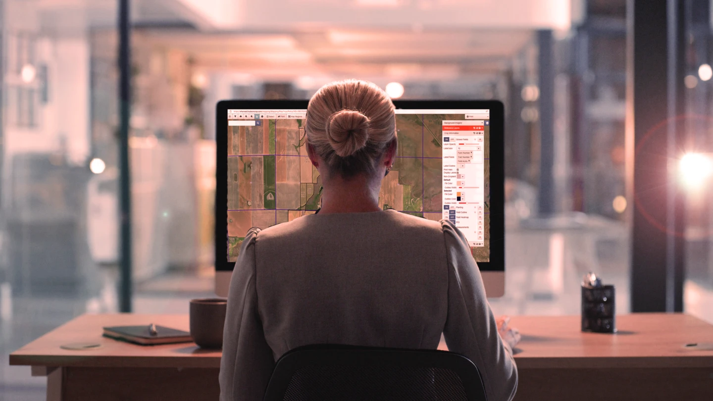 Women in front of computer using the Hudson Crop Precision Farming technology