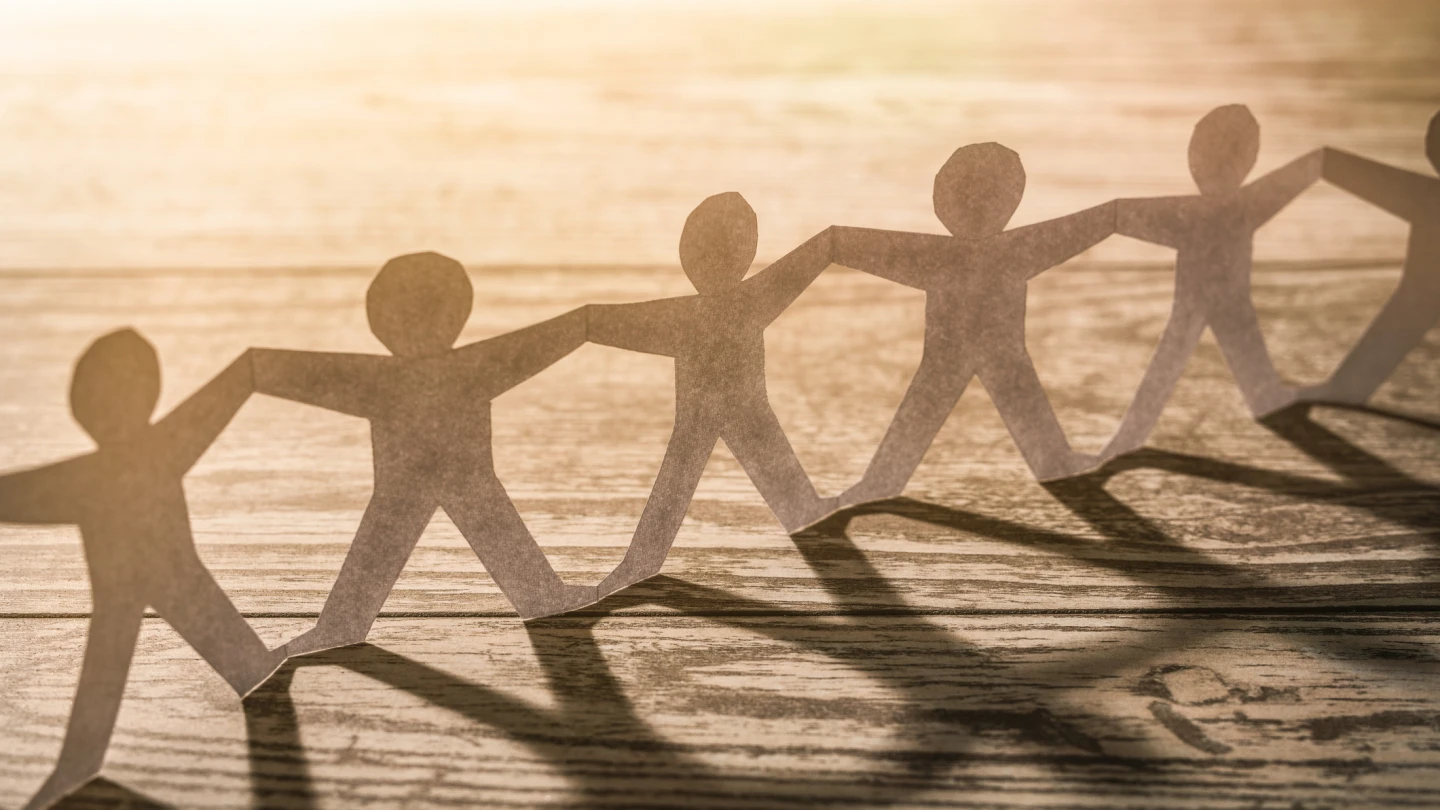 Team of paper chain people. Human chain with light and shadow.